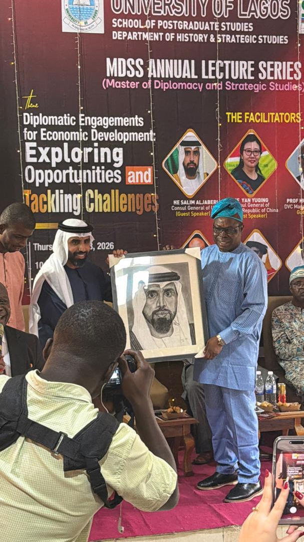 UAE Consul General holding portrait
